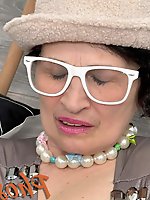 Older brunette seductively posing in leg stockings